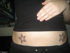 a woman's stomach with two stars on the lower part of her belly,