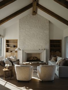 a living room filled with furniture and a fire place in the middle of a room