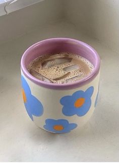 a coffee cup sitting on top of a counter next to a white window sill