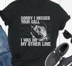 "A fishing graphic tee with the words \"Sorry I missed your call I was on the other line\" along with a fish bitting on a hook.  Choose your favorite shirt color - The design is light gray as shown.   Printed on a quality 50/50(polyester/cotton) blend t-shirt(or similar), so minimal to no shrinkage on these shirts." Sorry I Missed Your Call, Fishing Graphic, Fishing T Shirts, You Call, I Miss You, Favorite Shirts, I Missed, 50 50, You Choose