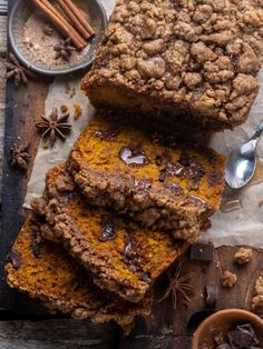 some brownies are stacked on top of each other next to cinnamon and anise