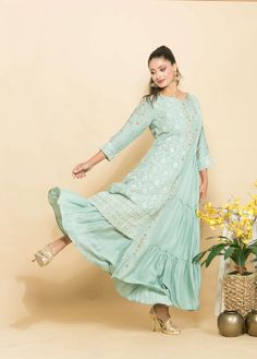 This light blue dress is a fusion of designer elegance. It features beautiful embroidery for a stylish, sophisticated look. • Component: 1 • Pattern: Embroidery • Type of Work: Embroidery work • Neckline: Round • Sleeve Type: Full Sleeves • Fabric: Cotton Silk • Color: Light Blue • Other Details: • Intricate Embroidery • Designer Dress with layered pleats • Occasion: Party wear, Any informal occasion Fusion Dress, Light Blue Dress