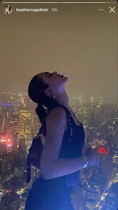 a woman standing on top of a tall building with her mouth open in the air