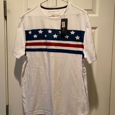 A Must Have! Size Medium. Great Shirt! White Relaxed Fit Americana Tops, Casual White Shirt With American Flag Print, Short Sleeve Cotton Americana Tops, Americana Style Short Sleeve Cotton Top, Short Sleeve Cotton Tops In Americana Style, Cotton Americana Style Short Sleeve Tops, White Americana Crew Neck Top, White Americana Relaxed Fit T-shirt, White Relaxed Fit Americana T-shirt