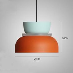 an orange and white bowl hanging from a ceiling fixture with the measurements for it's height