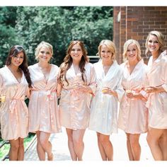 a group of women standing next to each other on a bridge wearing robes and ties