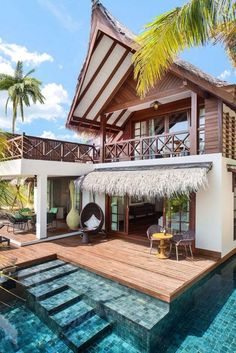 a house with a pool in front of it