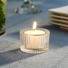 a lit candle sitting on top of a table