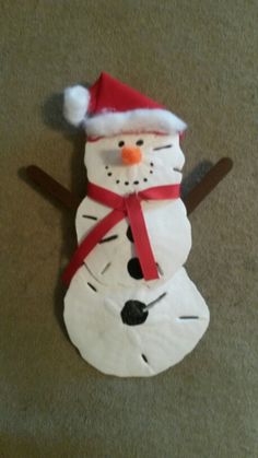 a snowman made out of toilet paper on the floor