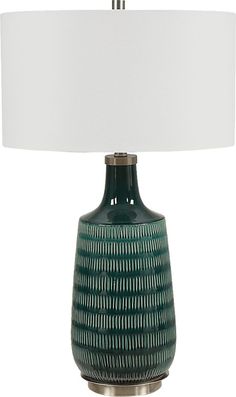 a green lamp with a white shade on it