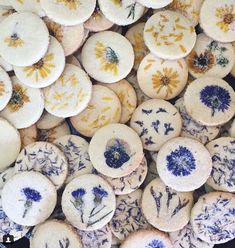 many different types of cookies with blue and yellow flowers on them are shown in close up