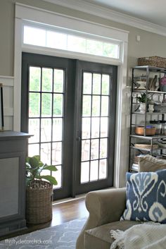 a living room filled with furniture and a fire place in front of a door that leads to a patio