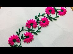 pink flowers on white cloth with green stems