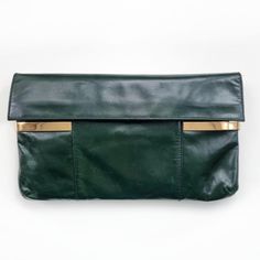 Beautiful vintage envelope clutch in dark green made from genuine, soft leather with gold detail. It has one main compartment lined with beige suede, small pocket, two loops to attach the strap and it fastens with two snap buttons. Perfect, stylish clutch bag for day out or special occasions. Made by Stado. Genuine leather, suede lining. Measures 30 x 17.5 × 2cm. Excellent condition, apart from some tiny leather scratch marks and a small darker shade mark at the back. Please see photo. B. Green Leather Travel Clutch, Green Leather Clutch For Travel, Leather Envelope Bag With Gold-tone Hardware, Leather Envelope Shoulder Bag With Gold-tone Hardware, Green Leather Rectangular Clutch, Green Rectangular Leather Clutch, Green Leather Clutch For Evening, Green Leather Evening Clutch, Green Leather Clutch With Removable Pouch