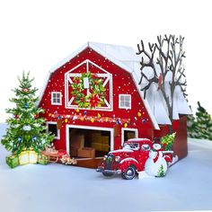 a red barn decorated with christmas decorations and trees