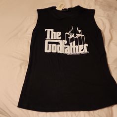 Brand New The Godfather Sleeveless Women Top Brand New Armpit To Armpit: 16 In Length: 26 In The Godfather Women, Black Sleeveless Top With Letter Print, Black Fitted Sleeveless Muscle Tee, Black Muscle Tee For Spring, Black Sleeveless Muscle Tee With Graphic Print, Black Graphic Print Sleeveless Muscle Tee, Black Sleeveless Muscle Tee With Letter Print, Black Muscle Tee With Letter Print For Summer, Summer Black Muscle Tee With Letter Print