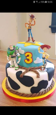 a birthday cake with toy story characters on it's top and the number three