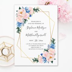 a wedding card with pink flowers and greenery on it, next to a gold geometric frame