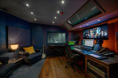 a home recording studio with multiple monitors and sound equipment