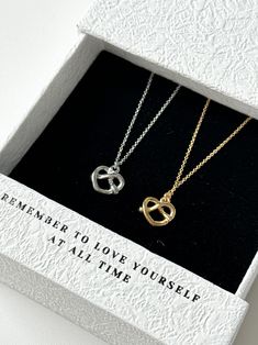 🎯Simple and lovely Pretzel Pendant. Great for a gift, everyday wearing, or a special occasion. Perfect for daily wear even work environment. Cute and unique.    -Color: Yellow Gold | Silver -Length: 41cm  -Pendant Size: 1.5cm  ✅[Jewelry Caring Tips] All our gold products are plated with a thick layer of 14K-24k gold giving durable plating at an affordable price. With the look of real gold, plated jewelry is a wonderful and affordable way to add a versatile choice to your jewel box To maintain the appearance, we strongly recommend avoiding water when wearing your piece, wiping them with a soft cloth after wear; keep them in proper storage to prevent oxidation. 💫[About our Packageing] Our Jewelry will be stored and shipped within an Anti Oxidation Zipper Bag along with our designed logo Li Food Necklace, Jewel Box, Zipper Bags, Real Gold, Cotton Bag, Jewelry Plate, Silver Gold, Womens Necklaces, Charm Necklace