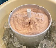 a food processor filled with ice cubes on top of a table