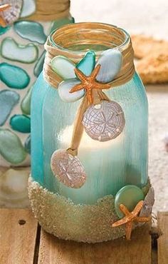 a glass jar with shells and starfishs on the lid sitting on a table