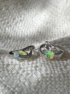 "Natural Ethiopian precious opal, blue fire and rainbow with cubic zirconia earrings.  14K White Gold over 925 sterling silver.  Measurements:  12.7 x 6.5 mm Teardrop opals: 7 x 5 mm Precious Fire Opals Some of the opal produced from the Wollo Province (Ethiopia) has an orange, yellow or reddish body color along with play-of-colour. The orange, yellow or reddish body color meets the definition of a fire opal, and the play-of-color meets the definition of a precious opal. Meeting both of these criteria, these opals could be called \"precious fire opals.\" E701B" Opal Earrings For Wedding, Silver Opal Earrings For Anniversary, Silver Opal Earrings For Wedding, Anniversary Silver Opal Earrings, Opal Gemstone Earrings For Anniversary, Opal Earrings For Anniversary - Fine Jewelry, Fine Jewelry Opal Earrings For Anniversary, Opal Jewelry With Matching Earrings For Anniversary, Anniversary Opal Earrings Fine Jewelry