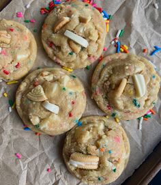 four cookies with shells and sprinkles on top