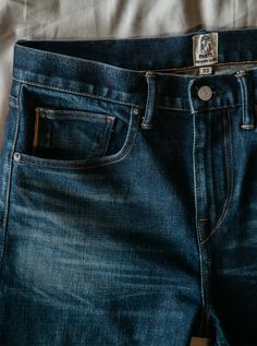 Slim fit Indigo Washed 14 oz 96% COTTON/4% POLYURETHANE Made in USA 4-Way stretch selvedge denim Model is 6'2" and wearing a size 32. Our premium denim is inspired by the classic vintage blue jean. Our Premium Japanese 4-Way Stretch Selvedge denim story starts in Japan where our fabric is developed at one of the oldest denim mills. We blend a unique 4 way stretch material with selvedge denim to create a specific amount of stretch and comfort you wouldn’t typically get with selvedge denim. This 3 Classic Dark Wash Pre-washed Bottoms, Denim Blue Jeans With Five Pockets For Everyday Use, Five-pocket Denim Bottoms, Classic Dark Wash Jeans For Everyday, Classic Indigo Jeans For Everyday, Everyday Dark Wash Bottoms With Five Pockets, Dark Wash Bottoms With Five Pockets For Everyday Use, Classic Indigo Jeans For Everyday Wear, Dark Wash Jeans With Five Pockets