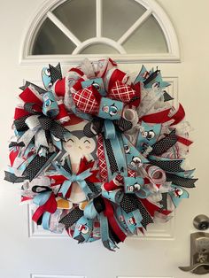 a red, white and blue wreath hanging on the front door for someone's house