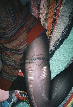 a woman's leg wearing tights and stockings with the word love written on them