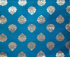 the blue and gold fabric has an intricate design on it's side, along with other patterns