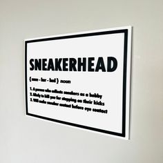 there is a sign on the wall that says sneakerhead