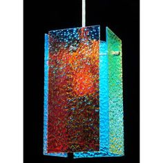 a multicolored glass light hanging from a ceiling