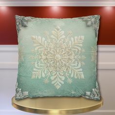 a decorative pillow on a gold table in a room with red walls and white trimmings