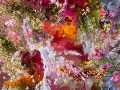 an abstract painting with flowers and leaves on it's surface, as well as the colors