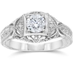 a white gold engagement ring with an intricate design