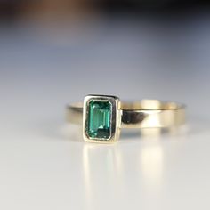 "This beautiful Emerald Gold Ring was handmade in Melt'm Jewelry Design Studio in California using 14k solid yellow gold band and 6x4mm emerald cut lab grown emerald stone. Emerald is featuring in 14k gold thick bezel setting. It's a lovely unisex ring for men and women. DETAILS ABOUT THE RING, MATERIAL AND STONES Ring Band: 14K solid gold Ring Band size: 3x1 mm thick flat band Gemstone: Lab grown Emerald Emerald size: 6mm x 4mm emerald cut Yellow gold or white gold options available from drop d Stackable 14k Gold Emerald-cut Birthstone Ring, 14k Gold Emerald Cut Stackable Birthstone Ring, Modern 14k Gold Emerald Ring For Anniversary, Gift Emerald Ring With 14k Stamp And Round Band, Emerald Ring Stamped 14k As Gift, 14k Stamped Emerald Ring As Gift, Heirloom Yellow Gold Stackable Emerald Ring, Emerald Cut Birthstone Ring In Yellow Gold, Heirloom Stackable Emerald Ring In Yellow Gold