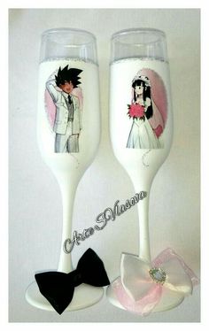 two wine glasses decorated with cartoon characters and bow ties, one has a bride and groom on it