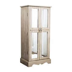 a tall wooden cabinet with glass doors