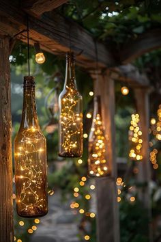 some bottles with lights inside them hanging from a wooden structure