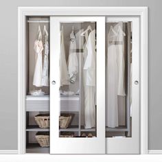 an open closet with white clothes and baskets