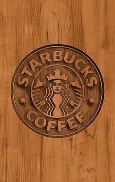 the starbucks logo is carved into wood