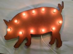 a pig shaped light up sign with lights on it