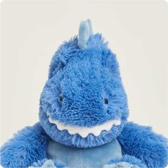 a blue stuffed animal with a toothy smile on it's face