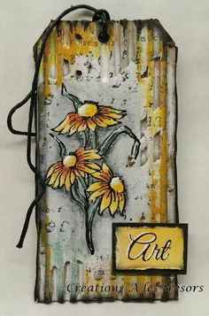 a tag with yellow flowers on it and the word art written in black ink next to it