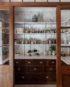 an open glass door with shelves full of food