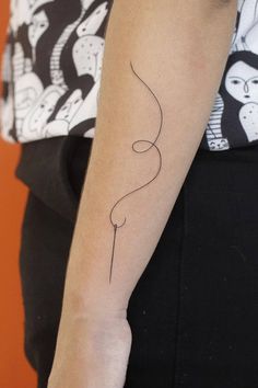 a woman's arm with a tattoo on it that has a balloon in the shape of a heart