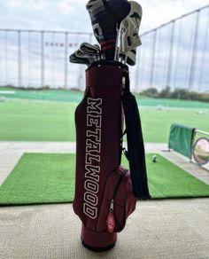 a golf bag sitting on top of a green field