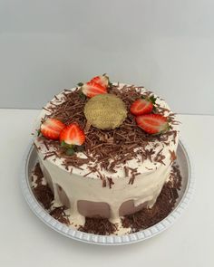 a cake with strawberries and chocolate shavings on top